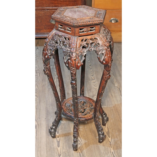 75 - A Chinese carved plant stand with marble top, height 82cm.