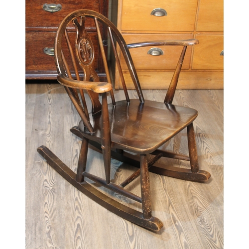 77 - An Ercol dark elm and beech rocking chair.