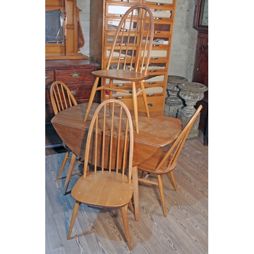 87 - An Ercol Blonde elm and beech drop leaf table and chairs.