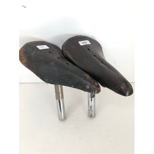 579 - Two vintage leather bicycle saddles comprising a Wrights and Lycett