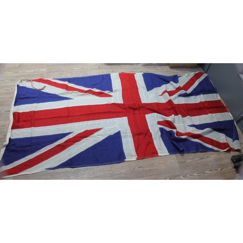 519 - A group of four vintage flags comprising three Union Jacks and one United States, 158cm x 81cm, 269c... 