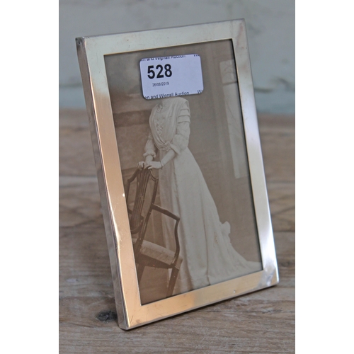 528 - A hallmarked silver photograph frame, height 15cm.