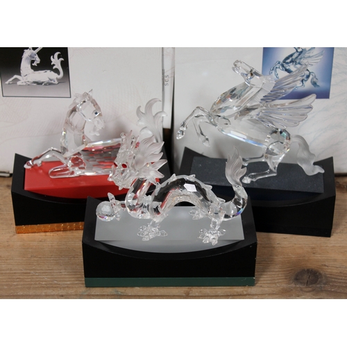 564 - A group of three Swarovski Magical Creatures figures comprising Dragon, Unicorn and Pegasus, boxed w... 