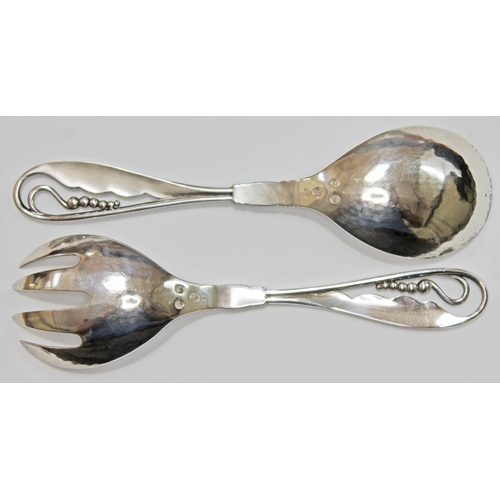 115 - A pair of Georg Jensen Danish silver salad serving spoons circa 1915-1930, hand hammered with leaf a... 