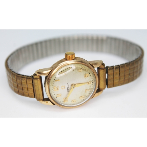 129 - A ladies 9ct gold Omega wrist watch, case diam. 20mm, gold plated sprung strap.