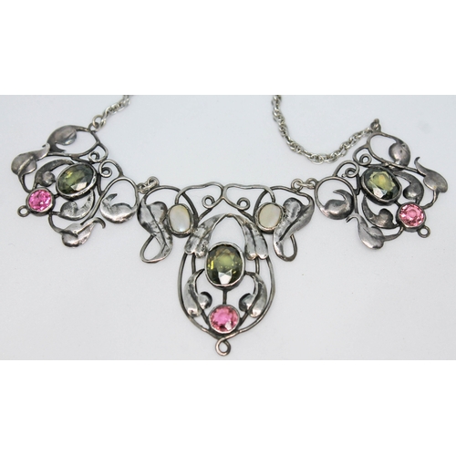 130 - An Edwardian white metal necklace formed as Art Nouveau stylised flowers and set with gemstones in t... 