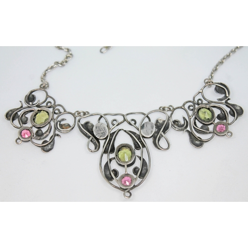 130 - An Edwardian white metal necklace formed as Art Nouveau stylised flowers and set with gemstones in t... 