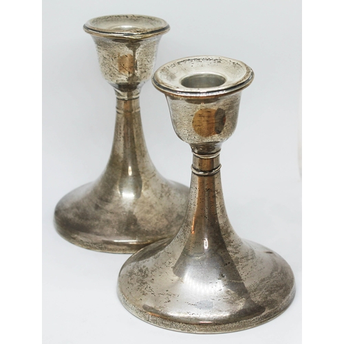 141 - A pair of hallmarked silver candlesticks, height 13cm.