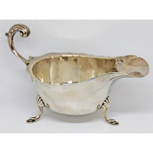 143 - A three footed hallmarked silver sauce boat, length 16.5cm, wt. 3oz.