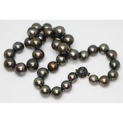 147 - A single strand of 35 black Tahitian pearls, 14ct gold and diamond set clasp, marked '14k 585', leng... 