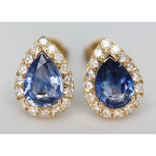 148 - A pair of 14ct gold sapphire and diamond earrings, each featuring a central pear cut natural sapphir... 