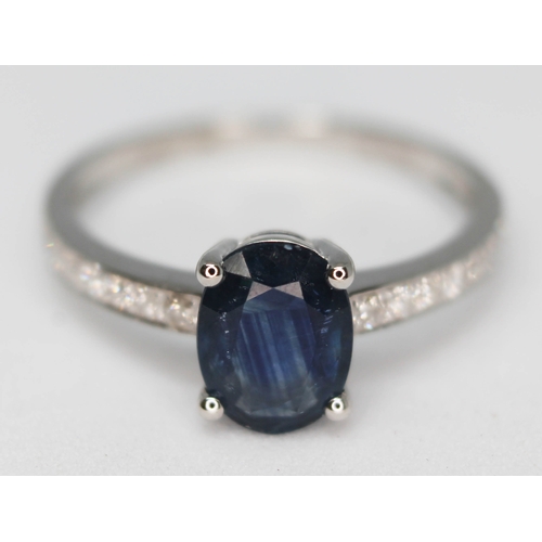 150 - A 14ct white gold sapphire and diamond ring featuring a natural oval cut sapphire approx. 1.24ct and... 