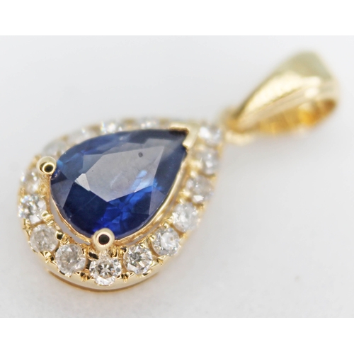 152 - A 14ct gold sapphire and diamond cluster drop pendant featuring a pear cut medium blue natural sapph... 