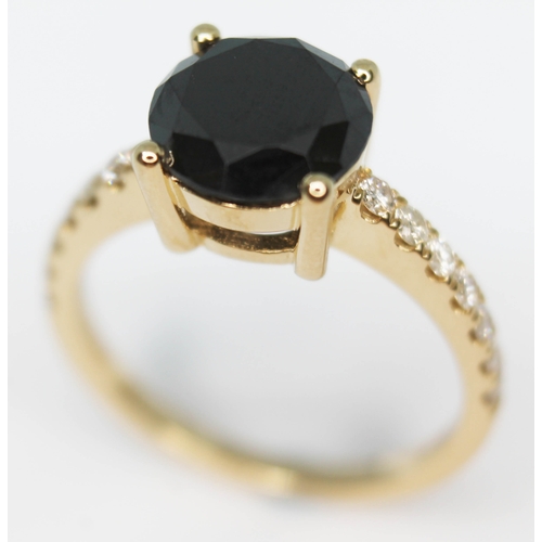 153 - A 14ct gold black diamond ring, the central stone approx. 2.10ct, diamond set shoulders, band marked... 