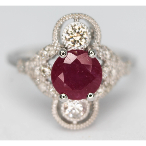 158 - An 18ct white gold ruby and diamond cluster ring featuring a round brilliant cut ruby approx. 0.98ct... 