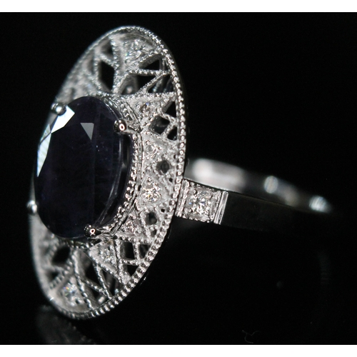 169 - An 18ct gold diamond and sapphire ring, the oval cut Kashmir sapphire approx. 3.45ct, surrounded by ... 