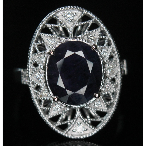 169 - An 18ct gold diamond and sapphire ring, the oval cut Kashmir sapphire approx. 3.45ct, surrounded by ... 