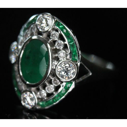 173 - An Art Deco style diamond and emerald ring, the central oval cut and bezel set emerald approx. 1.04c... 