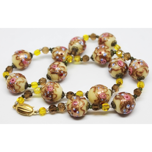 201 - A single strand of vintage Venetian glass beads with 9ct gold clasp.