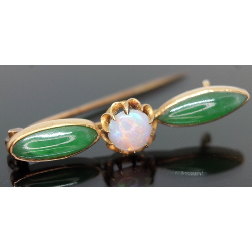 258 - A Chinese gold brooch set with an opal cabochon and two jade coloured stones, marked '20', gross wt.... 