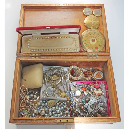 269 - A wooden box of mainly costume jewellery and also including a vintage clock compact, two American Po... 