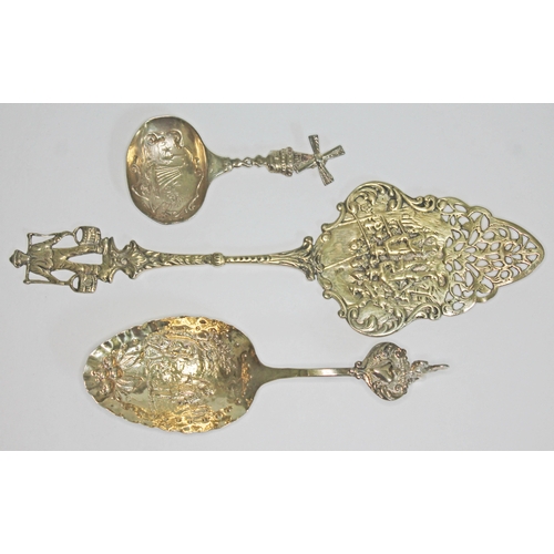 297 - Three items of Dutch silver gilt comprising a Berthold Muller caddy spoon, cake slice and another sp... 