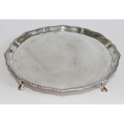 298 - A four footed hallmarked silver salver, diam. 26cm, wt. 19 1/2oz.