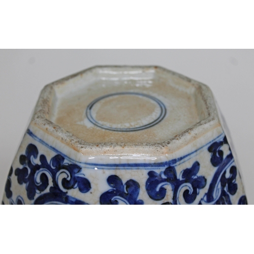 402 - A Chinese porcelain ginger jar and cover of octagonal form and decorated in blue white with lotus fl... 