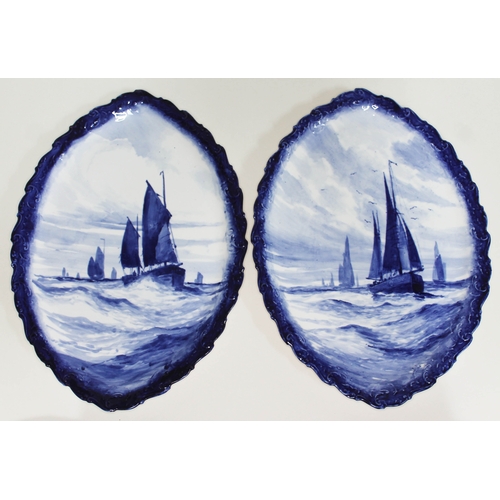 408 - A pair of Royal Crown Derby porcelain plaques, each decorated in blue and white with sailing boats, ... 