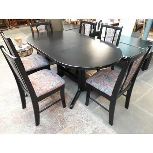 962 - A black extending dining table and 6 chairs