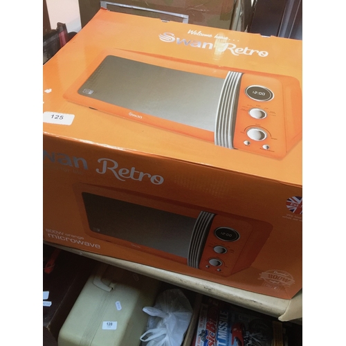 125 - A boxed orange Swan Retro 20 L capacity microwave.