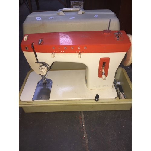 128 - Singer electric sewing machine with accessories, foot pedal, etc. in working order.