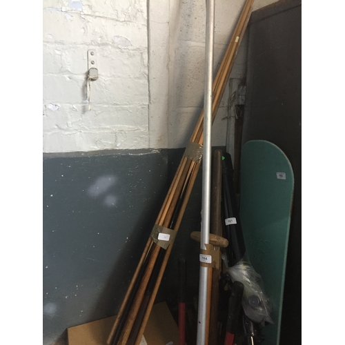 165 - A bundle of snooker and pool cues and box of balls