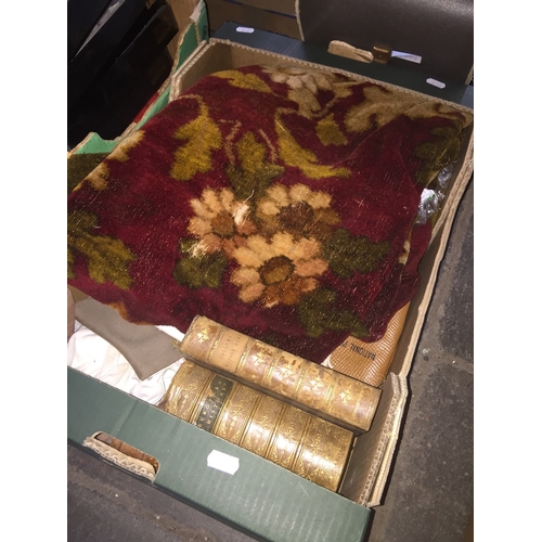 305 - A box of misc. including a chenille table cloth, a treen dice thrower, linen, leather bound antiquar... 