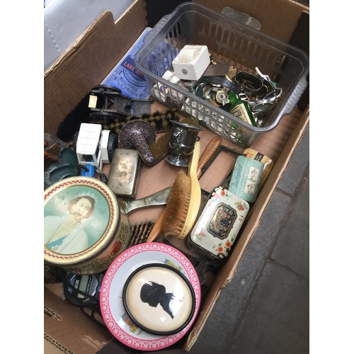 545 - A box of bric a brac including a lighter, a white metal serviette ring, brass, tins etc.