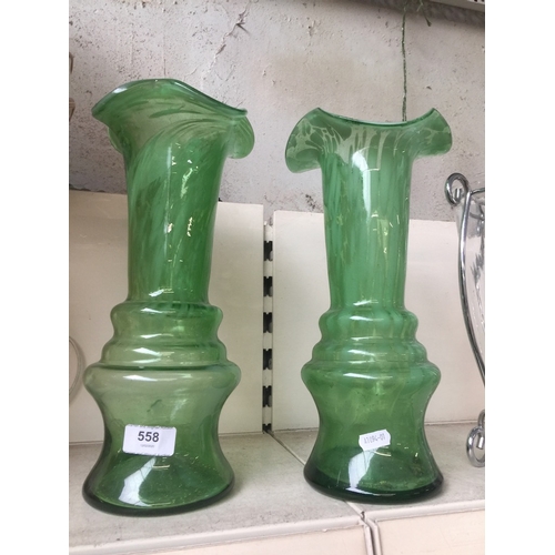 558 - A pair of green glass vases