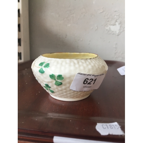 621 - A cream Belleek small bowl decorated with shamrock style leaves