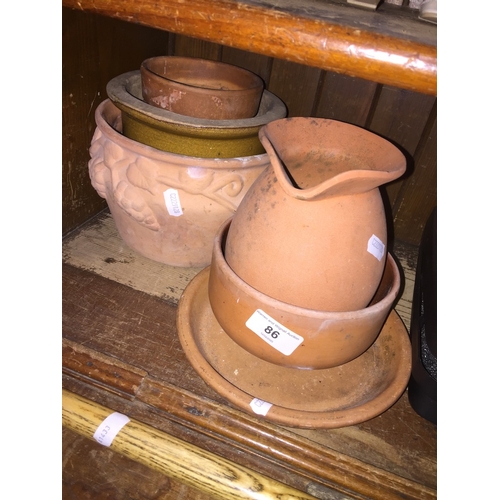 86 - A small collection of terracotta planters etc