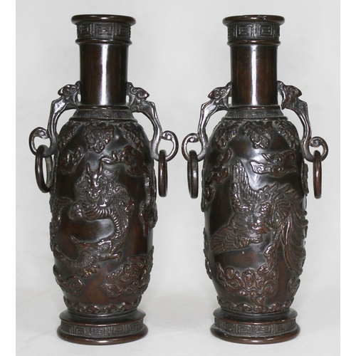 373 - A pair of archaic bronze vases, each with applied decoration depicting mythical birds, dragons and c... 