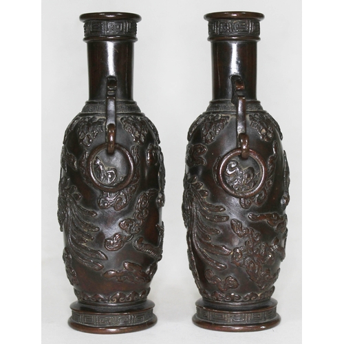 373 - A pair of archaic bronze vases, each with applied decoration depicting mythical birds, dragons and c... 