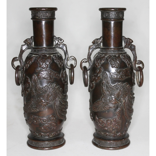 373 - A pair of archaic bronze vases, each with applied decoration depicting mythical birds, dragons and c... 