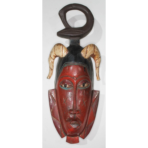 353 - A West African hand painted and carved Guro tribal mask, length 45cm.