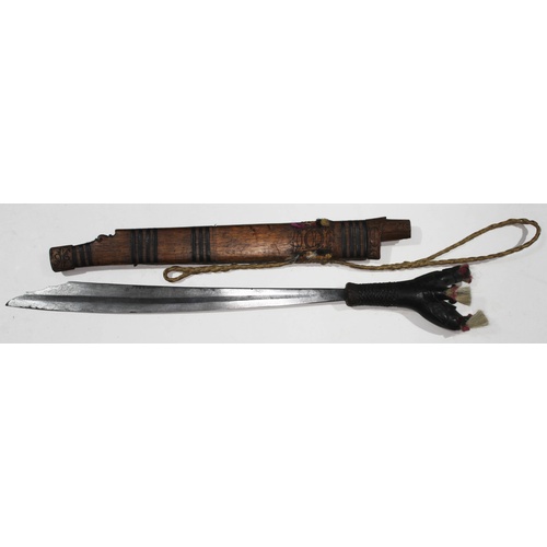 355 - A Dayak headhunters sword and carved wooden scabbard - Borneo.