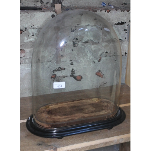 434 - A glass dome on wooden plinth, height 44cm, length 40cm.