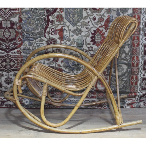 449 - A vintage cane rocking chair in the manner of Franco Albini.