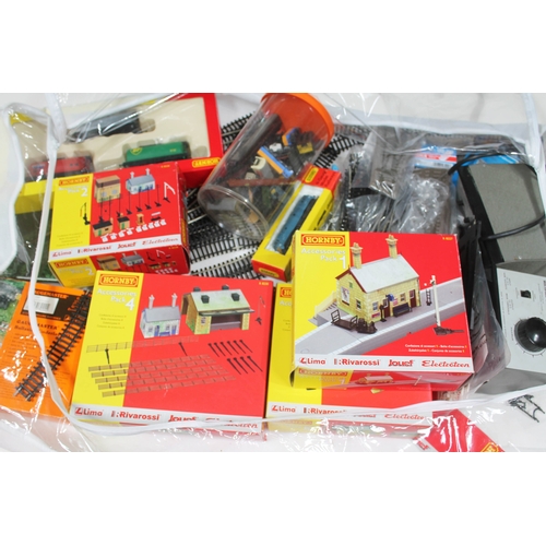 122 - Model railway accessories including various Hornby 00 gauge buildings and track, two controllers and... 