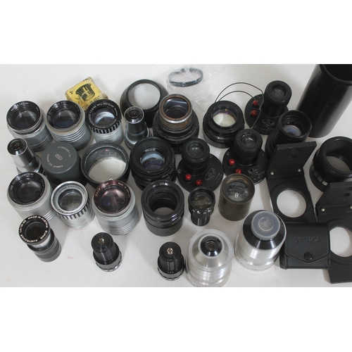 182 - A quantity of various camera lenses and accessories.