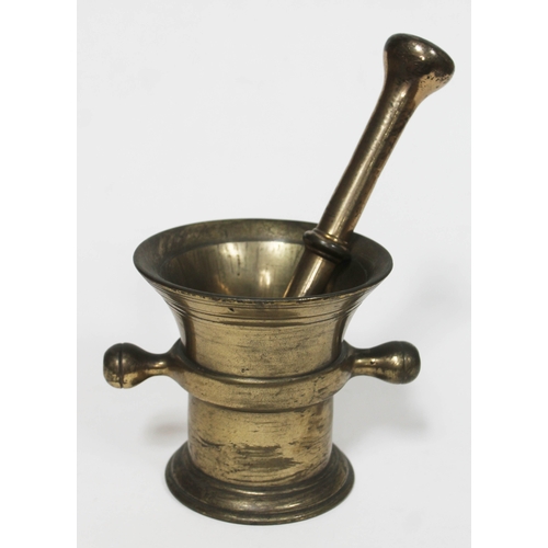 63 - A brass mortar and pestle, height of mortar 10.5cm, length of pestle 21cm.