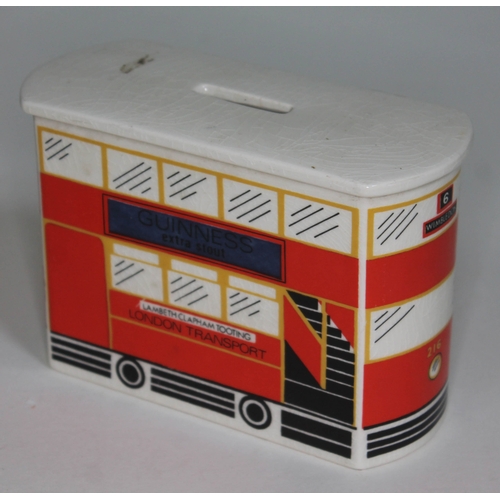 244 - A Carlton Ware money bank formed as a London bus with Guinness advertisement to side, length 15cm.