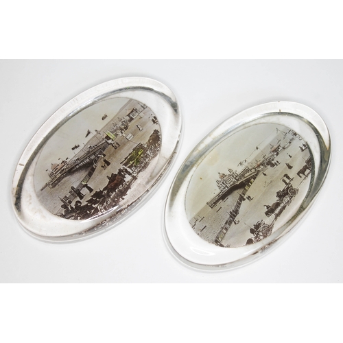 249 - A pair of Edwardian glass paperweights with souvenir seaside scenes.